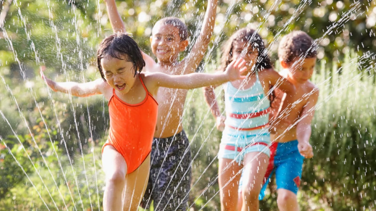screen-free-large Children playing in a sprinkler