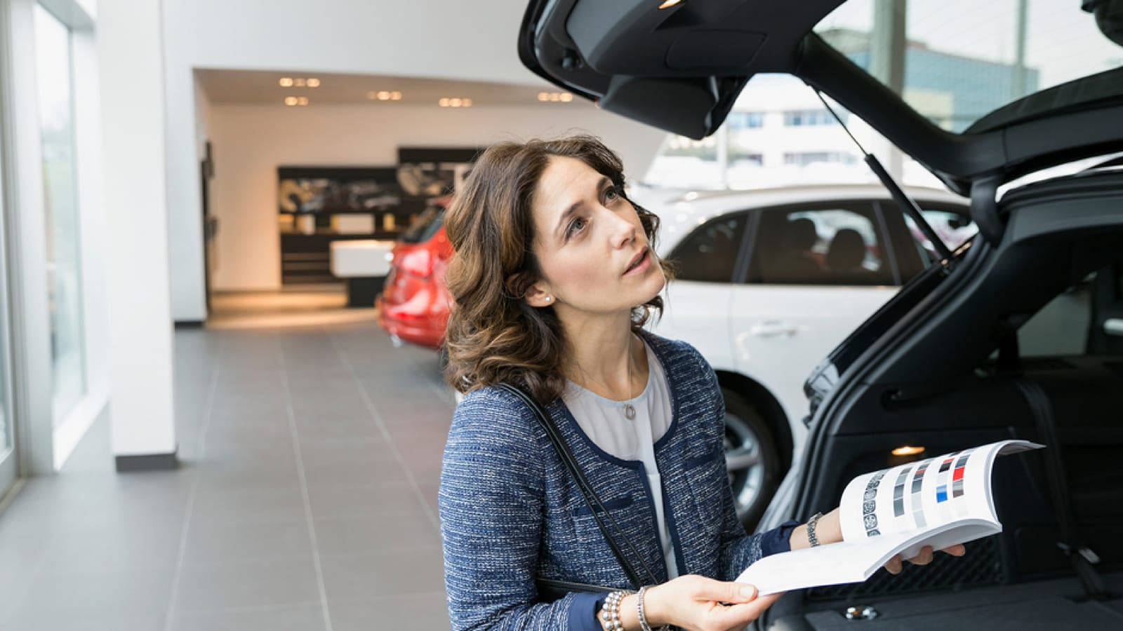 amicovered_main-1 Woman looking at cars to buy