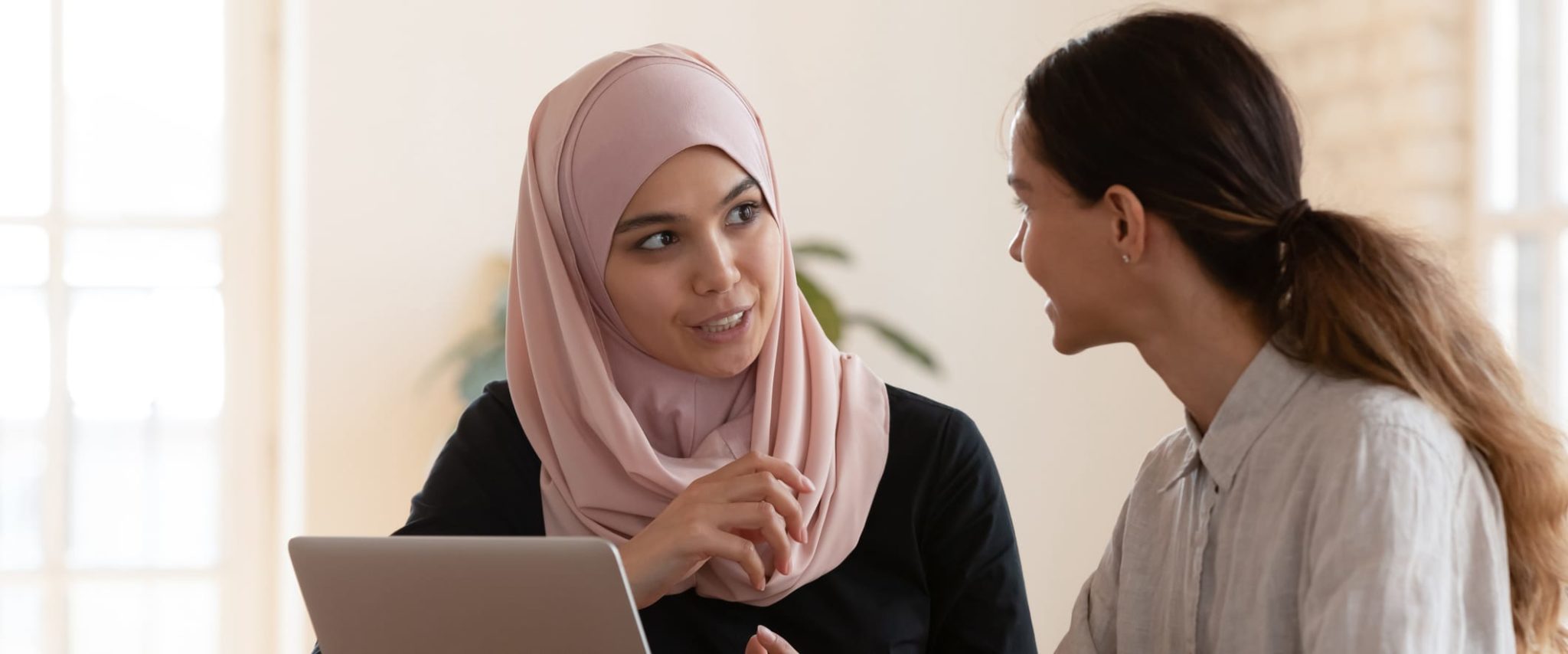What is a High-Deductible Health Plan (HDHP)? Two Young Women in Meeting
