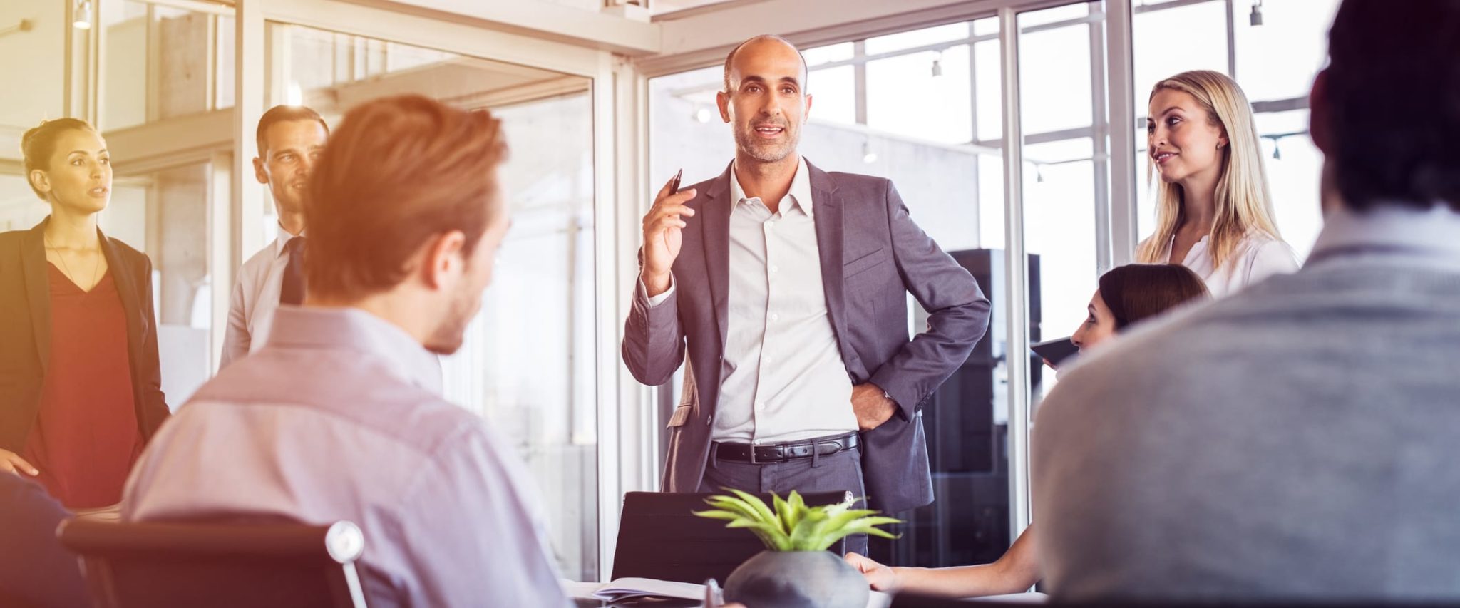 How to Effectively Communicate Your Group Benefits Plan Male Professional Leading Office Meeting