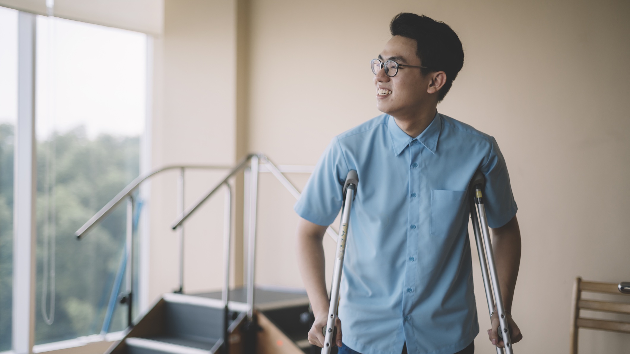Young male on crutches Asian man on crutches