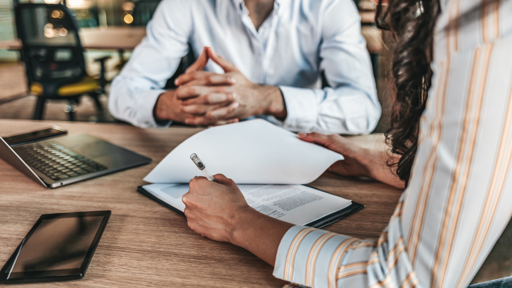 two people discussing business man and woman going over paperwork
