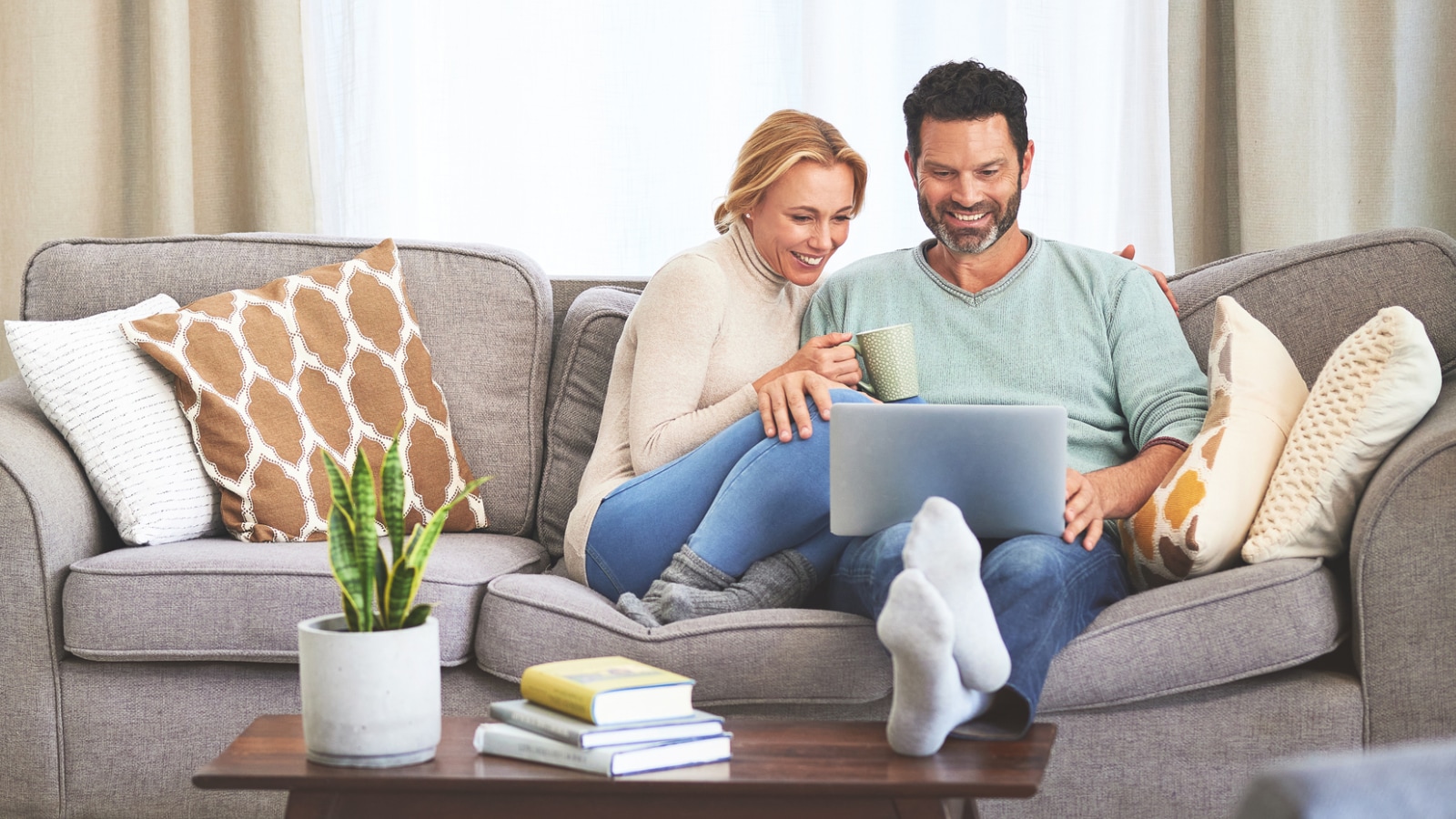 PPO vs. HMO couple reviewing insurance on their laptop